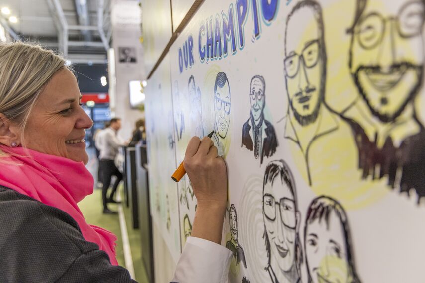 Cartoon artist drawing at BAU 2025